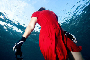 girl in red dress is ascending by Rico Besserdich 